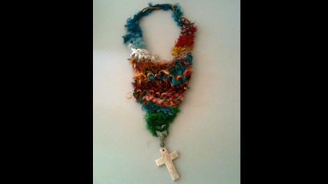 Crucifix and colourful materials making an art work