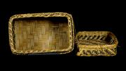 A lidded, rectangular, black and natural coloured basket  with a diamond design.