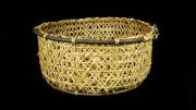 A straight sided and round basket made from split bamboo with a willow rim.