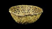 A round basket with sloping sides. It is made frosplit bamboo with a willow rim.