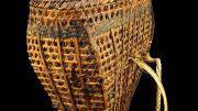 An open wickerwork basket made from split bamboo, rattan and rope straps.