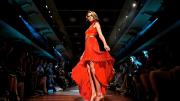 Model in red dress at end of catwalk