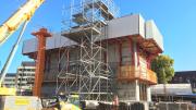 A square concrete box with fencing on the top.  This will be the lift that takes visitors up the Museum. 