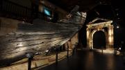 Image of a large wooden ship on display in a Museum