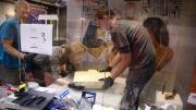 Preparing a sarcophagus and positioning it within a display case