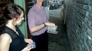 Image of two people inspecting shelves filled with badge dies.