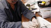 Taxidermist examines birds head after brain and eyes are removed