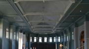 The interior of a heritage building with ornate roof and light green walls.