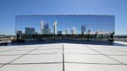 A large square on a top of a building with mirrored square finishing reflects the Perth city skyline.