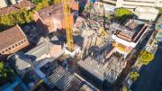 birds eye view of construction shows large crane in centre of construction site