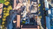 view above construction site shows heritage buildings surrounding new building being constructed