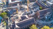 birds eye view of construction with victorian era buildings in foreground and construction of new building in background