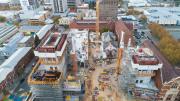 An aerial view shows the two lift cores on either side of the site