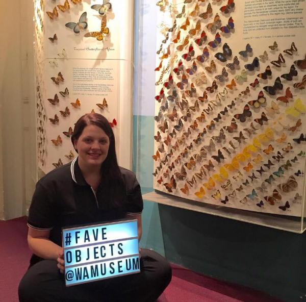 Amanda Marchese holding a #faveobjects sign in the WA Museum - Perth
