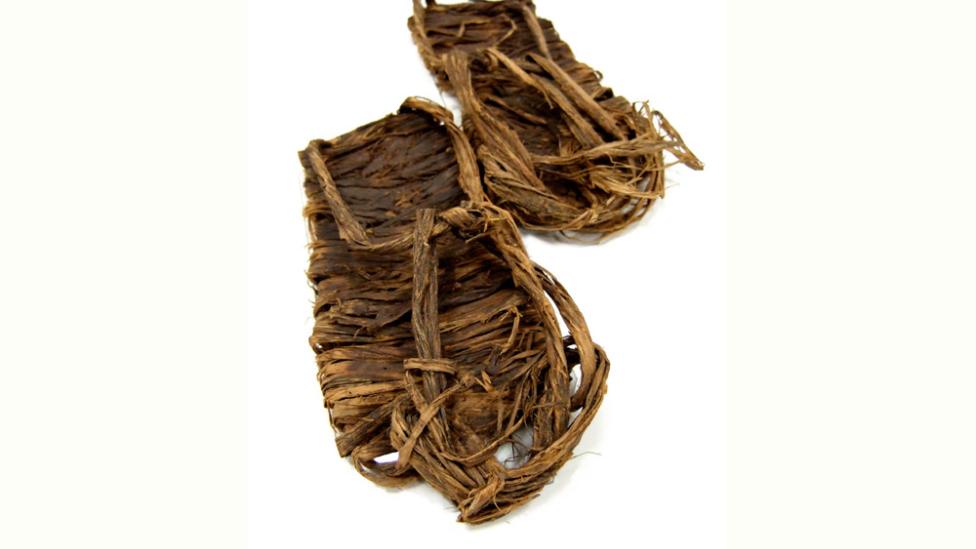 A pair of sandals constructed from bark