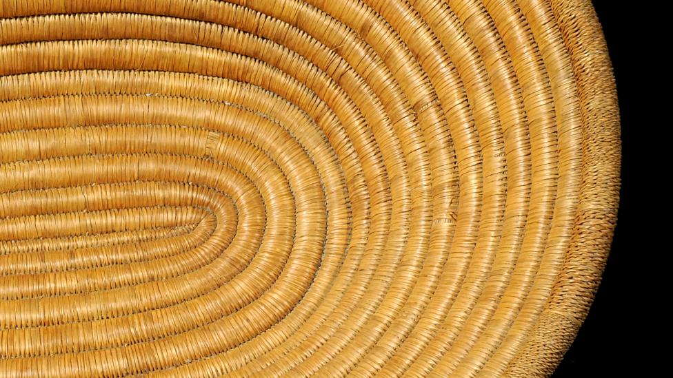 A coiled stitched basket. 