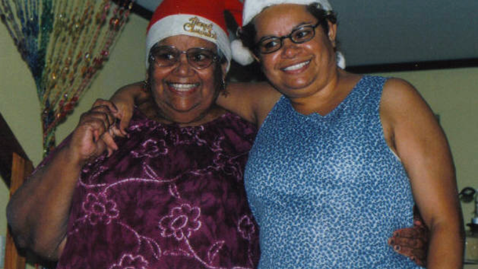 "Two women standing side by side. They are mother and daughter."