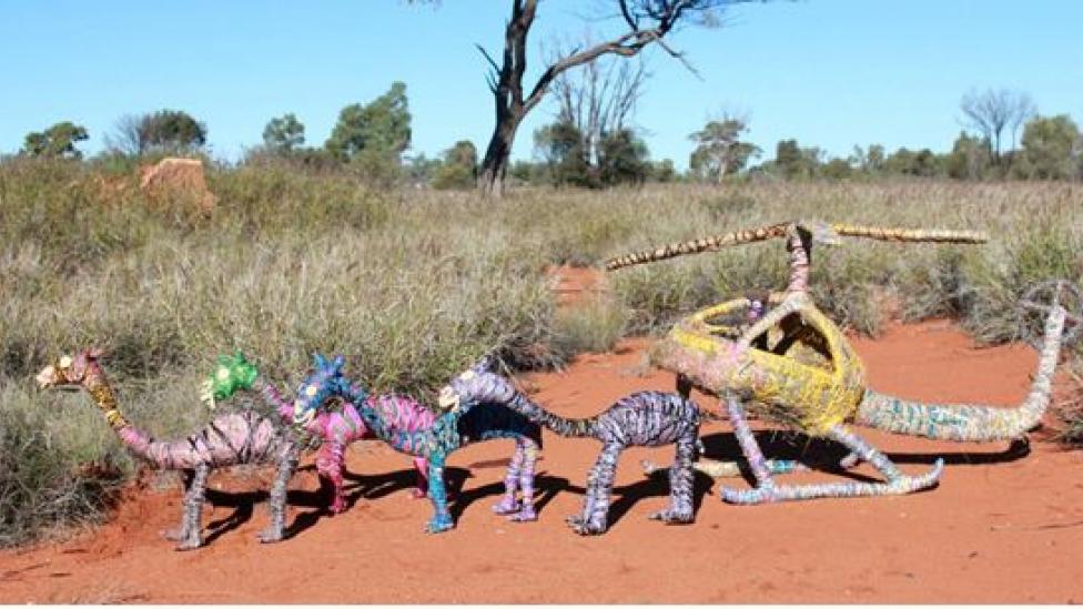 sculpture of a helicopter chasing camels, Crafted from wire, tjanpi (wild harves