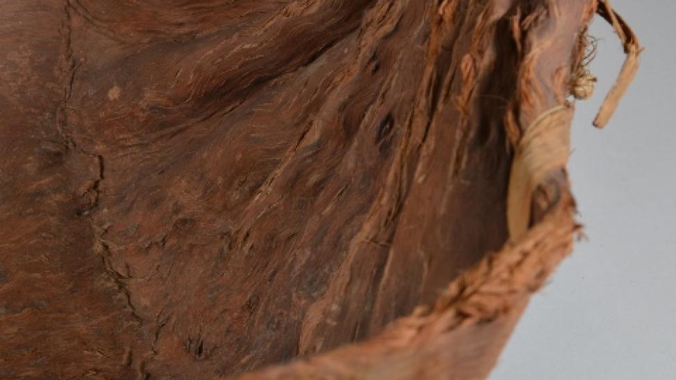 "Long wooden handcrafted bowl in the shape of a long deep dish"