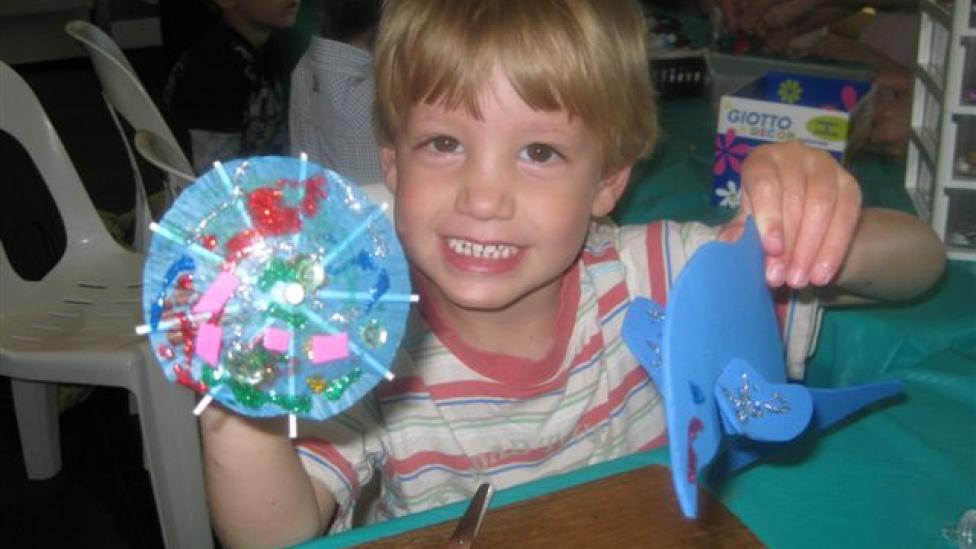 Child making craft at Marine Discovery Mission