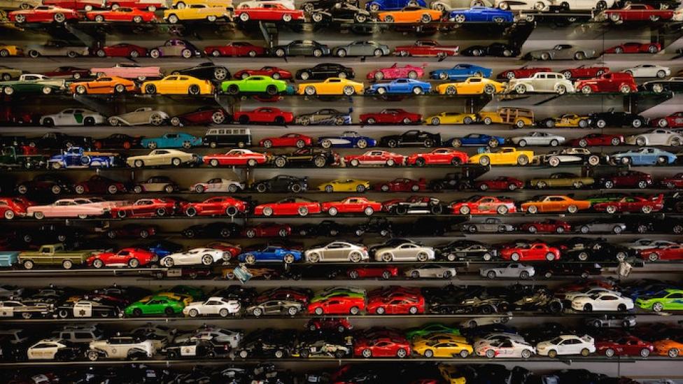 A large collection of toy cars on display shelves.