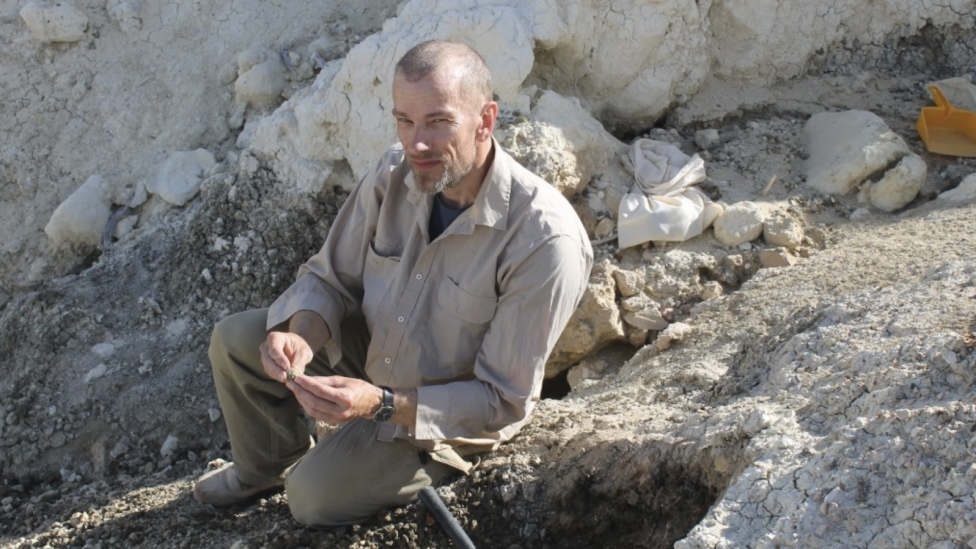 A man sitting on a rocks.