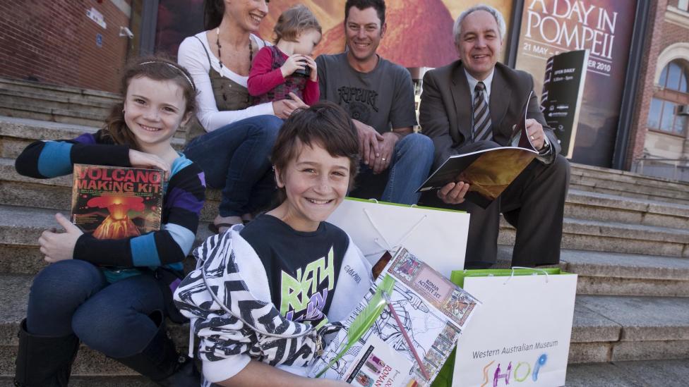 A family with Museum CEO Alec Coles celebrating the 100,000th visitor to the exhibition