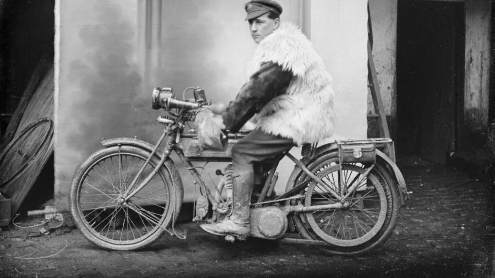 Corporal James Davie Renner, 4th Divisional Signals Company, of Fremantle, Western Australia sitting on a motorbike