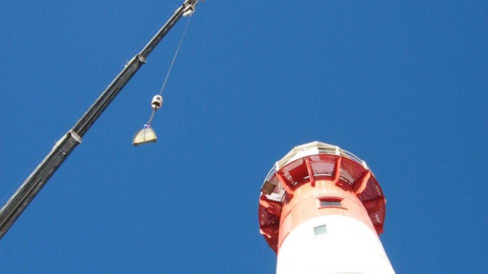 A crane removing the lens from the Port Moore lighthouse