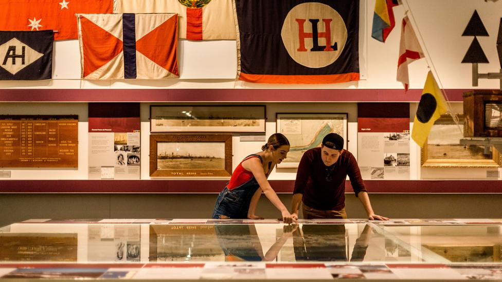 A young man and woman standing inside a WA Maritime Museum gallery