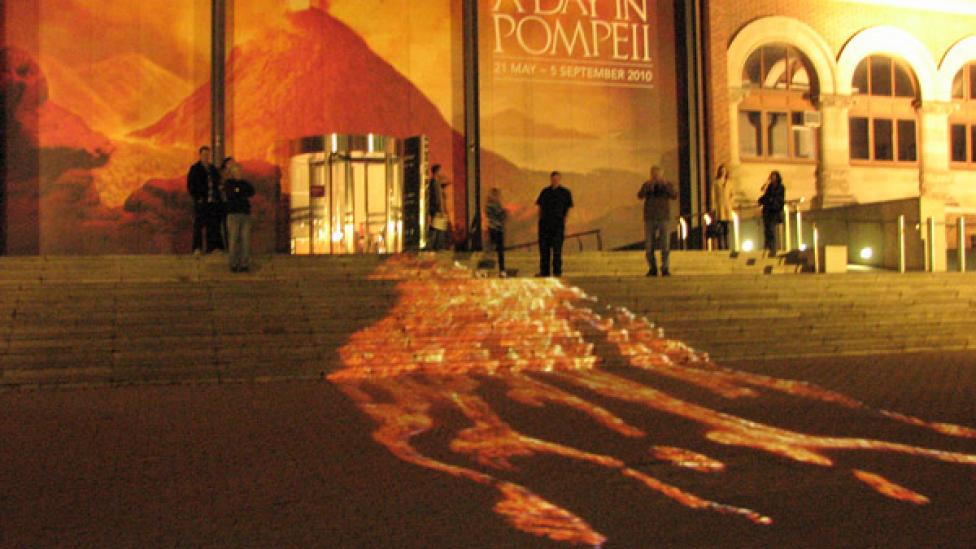 Projection of lava flowing over the steps to the entrance to the WA Museum