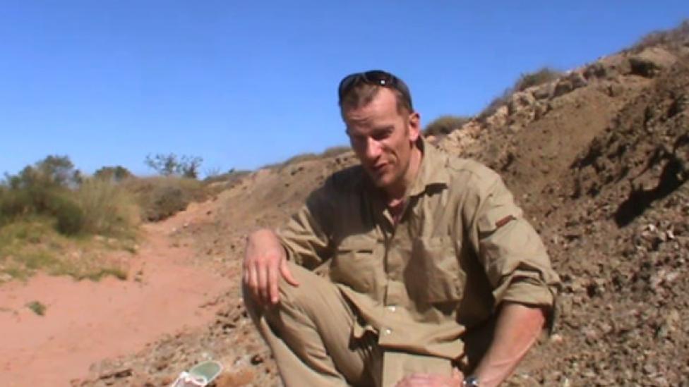 Mikael Siversson crouched over to talk to the camera Image copyright of WA Museum