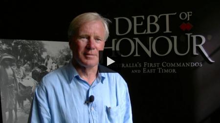 James Dexter standing in front of entry to the exhibition Debt of Honour